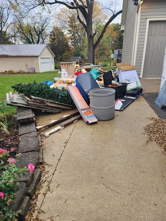 Dumpster being loaded with debris for Commercial Dumpster Rental in Oaklyn
